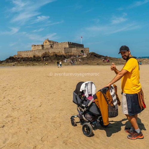 A young father enjoying the summer on the Grande Plage du Sillon de Saint-Malo in French Brittany, France